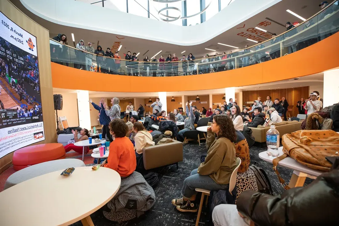 Students watching a basketball game at the Schine Student Center.